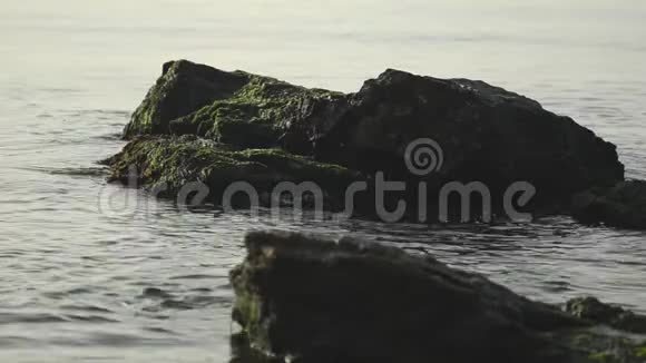 海水在海边的岩石间形成小浪视频的预览图