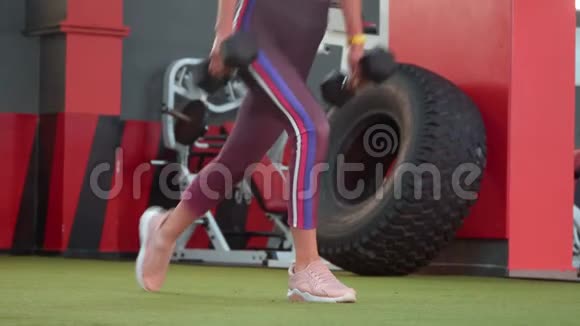 穿着运动服的漂亮运动健身女孩正在健身房做向前冲的运动视频的预览图
