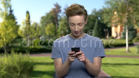 青少年男孩在户外使用手机视频的预览图