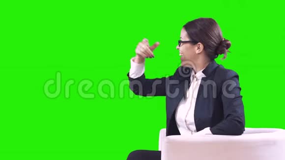 一个快乐的商业女人的肖像她把手伸向绿色的屏幕未来的技术视频的预览图