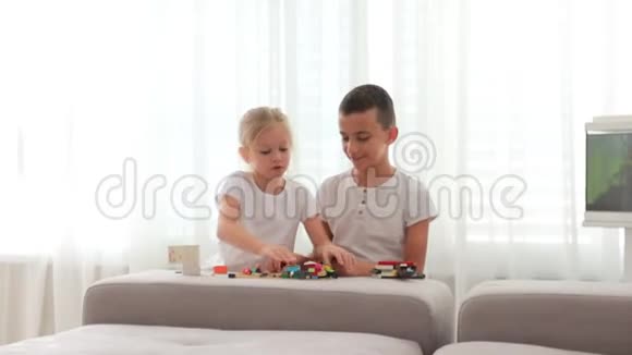 可爱的小朋友男孩和女孩在家玩建筑积木建筑玩具视频的预览图
