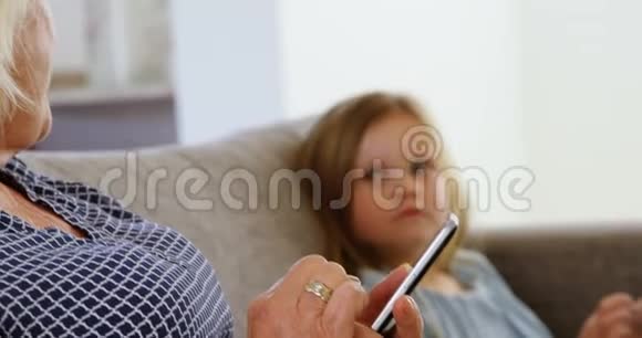 外婆在客厅4k的时候用手机看孙女视频的预览图