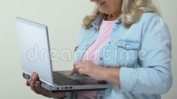 成熟女性在笔记本电脑上输入电子邮件竖起大拇指在线申请视频的预览图