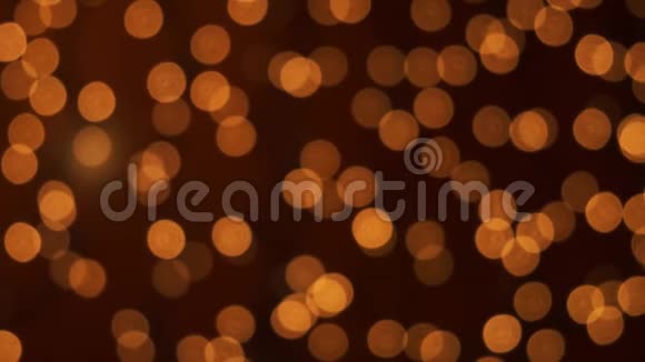 橙色的圣诞照明在离焦模糊的抽象粒子背景视频的预览图