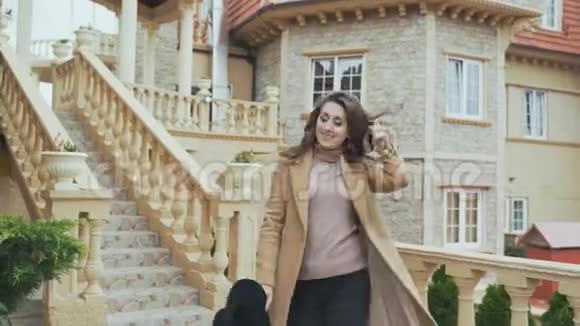 一位迷人的年轻女子穿过城堡欣赏古老的楼梯和塔楼穿着时尚的衣服穿着视频的预览图