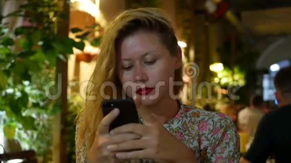 进攻性女孩使用智能手机写信息聊天女人在电话里寻找信息伤心坐着坐着视频的预览图