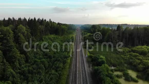 鸟瞰夏天在农村现场训练火车在日出时穿过农村视频的预览图