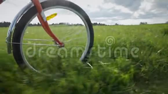 一个红色的自行车轮骑在草地上视频的预览图