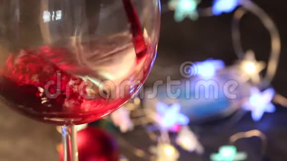 在黑暗的节日背景上用酒杯斟上红酒酒色缤纷视频的预览图