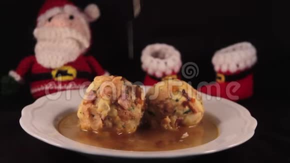 在肉汤里放两个漂亮的小面包背景是圣诞老人外加一点帕尔马干酪视频的预览图