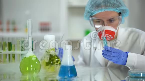 生物化学家在带蓝色物质的试管中注入油状液体检查反应视频的预览图