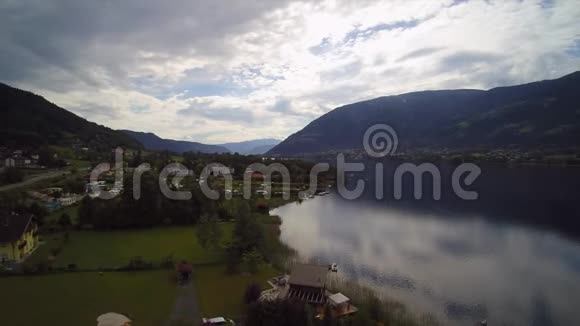 无人驾驶飞机观看奥地利湖Ossiacher海上船只和森林山镇OssiachVillach视频的预览图