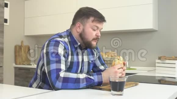 胖胡子男人吃垃圾食品芝士汉堡伤害快餐卡路里慢动作柠檬水视频的预览图