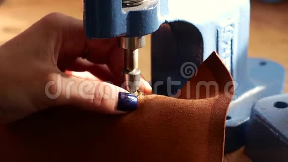 女工匠使用压力机安装金属小孔的Geniune皮革产品关门视频的预览图