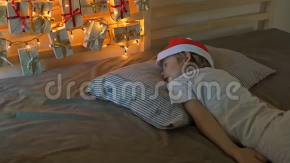 小男孩醒来时看到一张挂在床上的历法被圣诞灯照亮了准备好准备视频的预览图