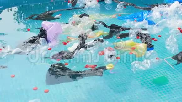 地球污染的概念塑料袋和瓶子漂浮在水面上视频的预览图