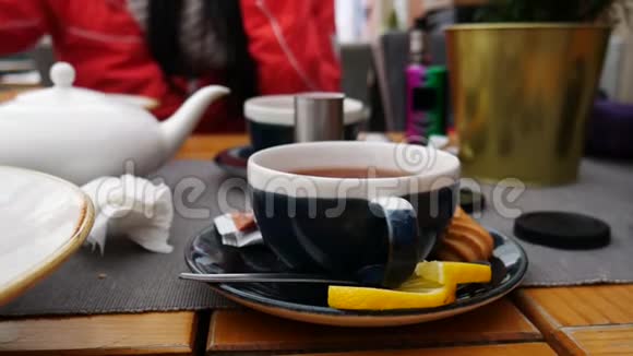 人和饮料的概念一个女人手把茶倒在咖啡馆的杯子里视频的预览图