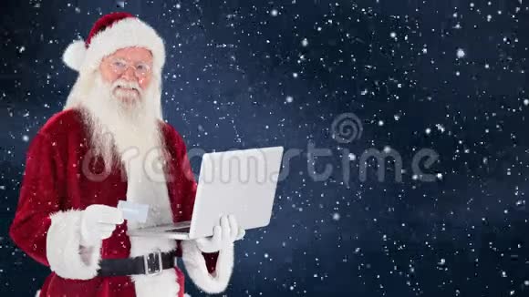 圣诞老人条款手提笔记本电脑和下雪视频的预览图