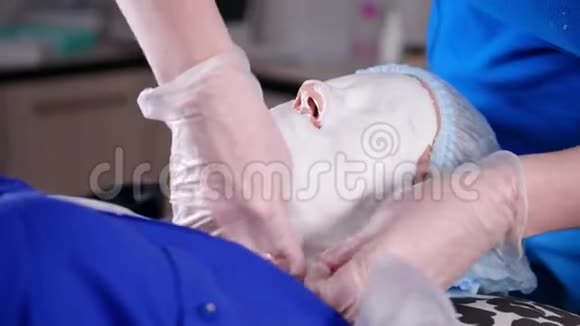 美容诊所年轻女子得到美容治疗将干燥面罩的边缘剥离视频的预览图