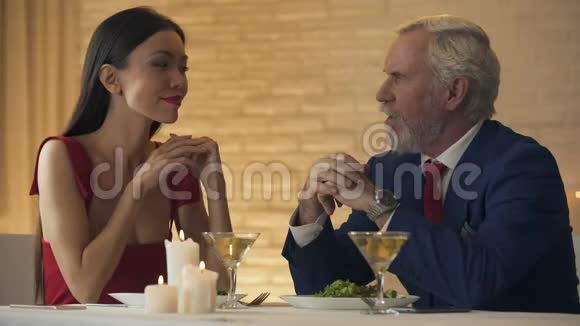 老头邀请年轻女朋友跳舞在餐馆里度过浪漫的夜晚视频的预览图
