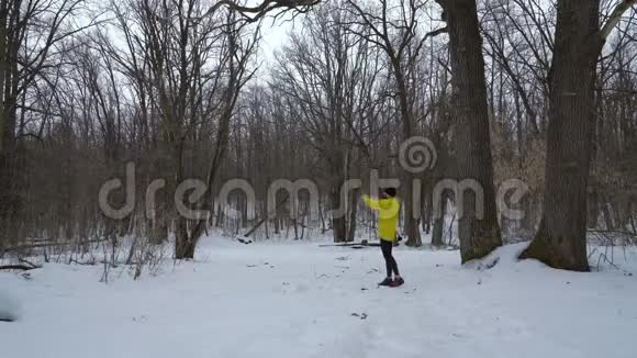 穿着黄色外套的蓄须运动员在冬天的森林里自由活动视频的预览图