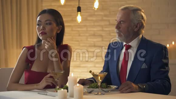 向年轻女朋友求婚的老年百万富翁在餐馆约会视频的预览图