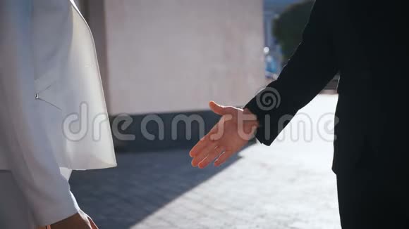 商业人士握手商务办公大楼在户外的商务男性和商务女性之间握手视频的预览图