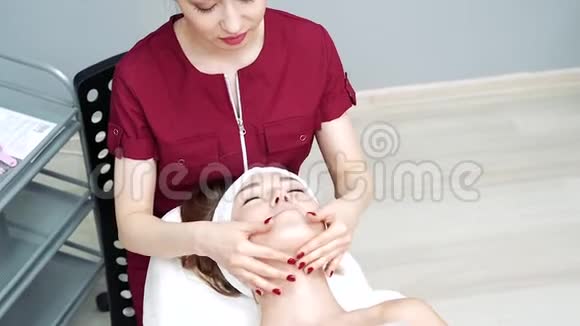亚洲女性美容师为年轻女性做放松的面部按摩视频的预览图