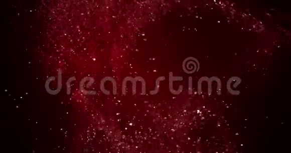 圣诞节红色渐变闪光爆炸尘埃粒子从顶部黑色背景与波克流动运动假日视频的预览图