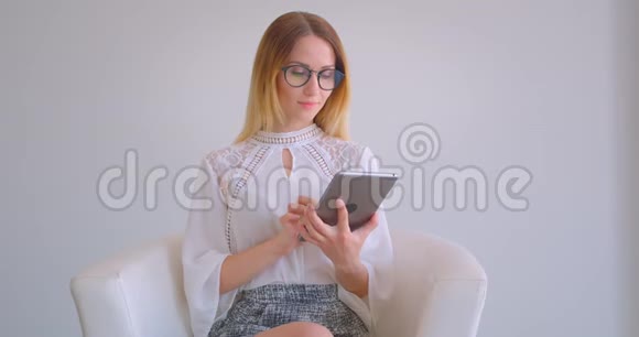 年轻漂亮的白种人女商人用平板电脑拍摄的特写肖像并在镜头中显示绿色屏幕视频的预览图