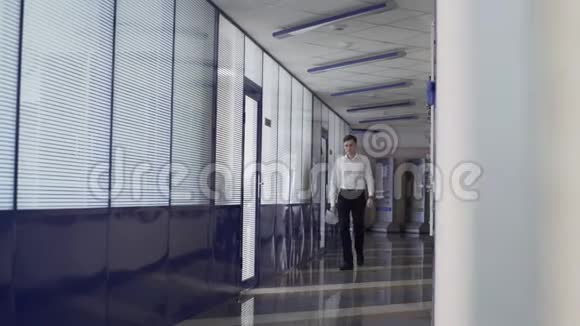 商人在大公司大楼大厅里散步视频的预览图