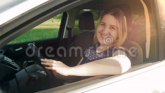 慢镜头视频美丽的微笑女人坐在车里看着窗外视频的预览图