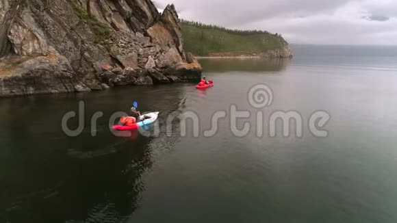 湖上有两只独木舟游客们在海湾上划独木舟空中无人机射击视频的预览图