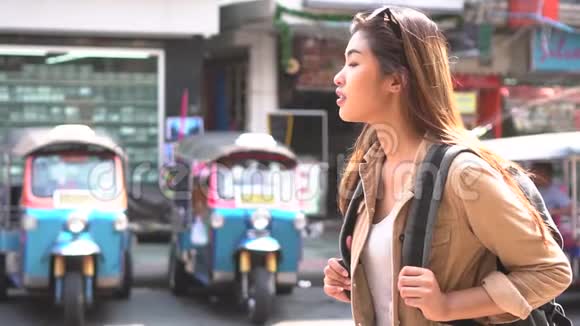 年轻的亚洲女性旅游背包客在前往泰国的过程中走在高三路上视频的预览图