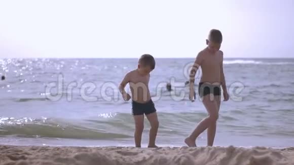 两个男孩在海滩上玩耍视频的预览图