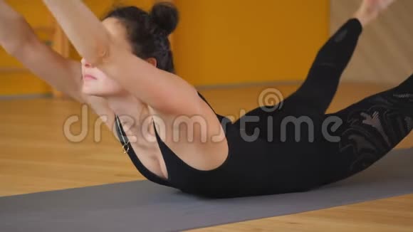 女孩做伸展运动呼吸练习普拉纳亚马光极简工作室练习瑜伽的年轻美女视频的预览图