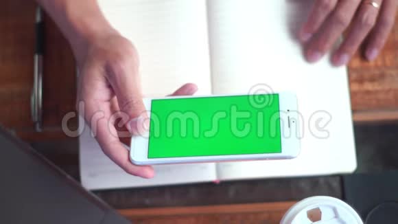 紧紧抓住一个男人手握着手机看着绿色屏幕互联网技术和智能手机概念视频的预览图