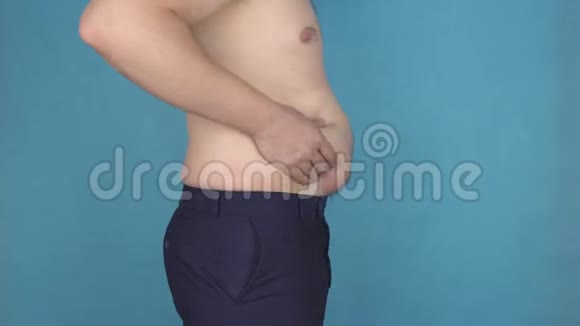 两个男人接触脂肪堆积在脂肪堆积的肚子上超重不健康的饮食蓝色背景问题视频的预览图