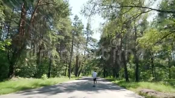 一个人在公园的空路上骑滑板视频的预览图