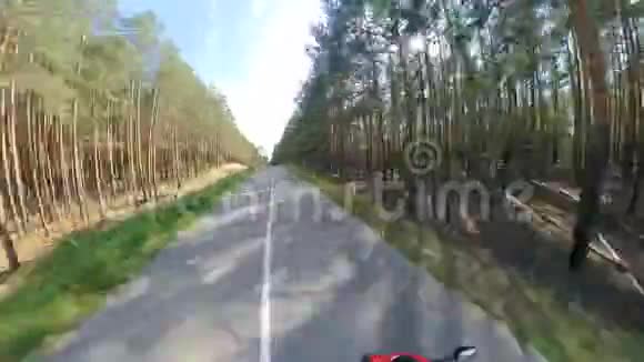 俯瞰森林道路和骑着摩托车的人摩托车在路上视频的预览图