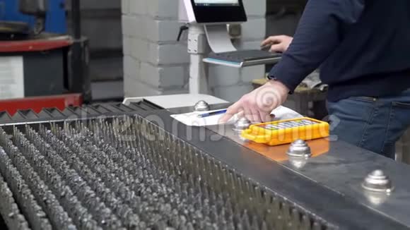 工程师对铁制零件的纸制工程进行检验视频的预览图