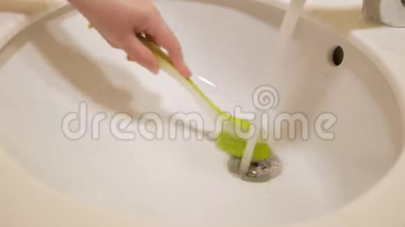 女人正在用刷子清洗水槽手特写视频的预览图