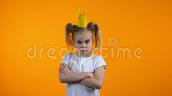 淘气的女孩戴着纸冠双手交叉在胸前皱着眉头尴尬的年龄视频的预览图