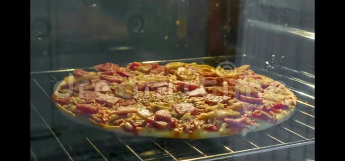 蘑菇和火腿比萨饼在烤箱中烹饪时间流逝视频的预览图