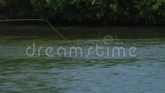 渔夫投下了浮子在河上钓鱼小电流美丽的大自然视频的预览图