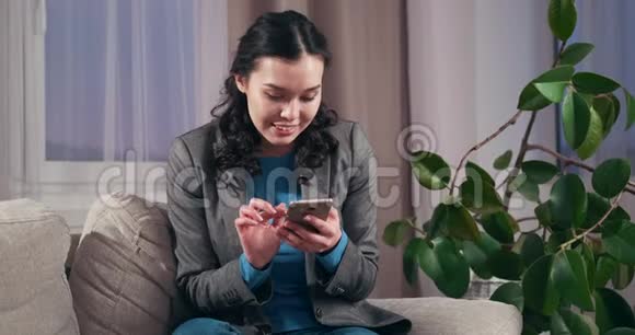女商人在家中使用手机视频的预览图