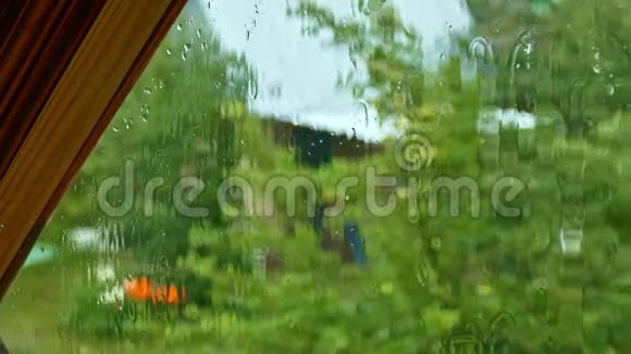 在雨中透过窗户向老花园眺望最高的景色视频的预览图