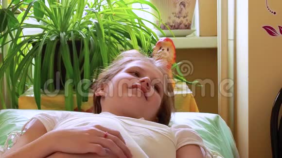 爸爸抱着生病的小女儿她躺在床上高兴地对父亲微笑视频的预览图