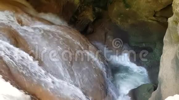 强烈的水流在山洞里地下的小瀑布水流在石头之间断裂视频的预览图