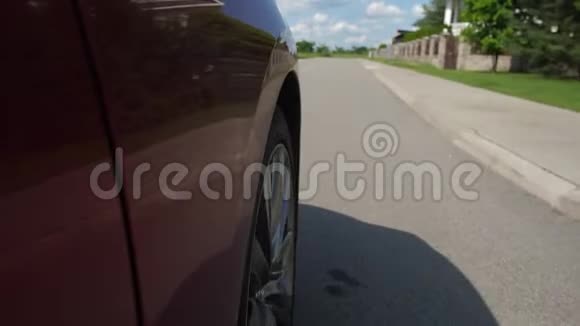 汽车车轮在郊区的村舍道路上旋转视频的预览图